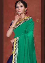 Charming Blue and Green Patch Border Faux Georgette Designer Half N Half Saree